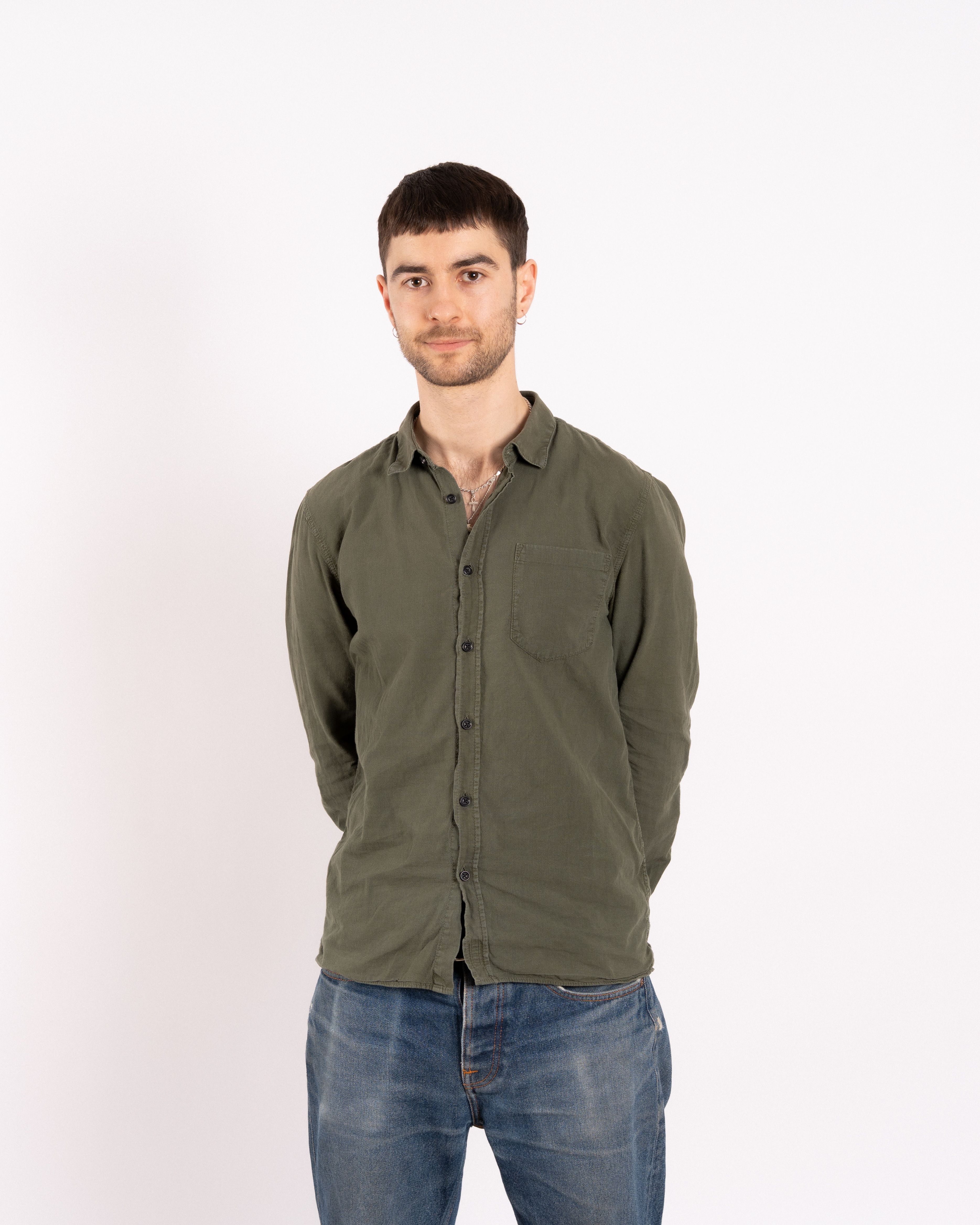 picture of keran with a slight smile and hands behind the back