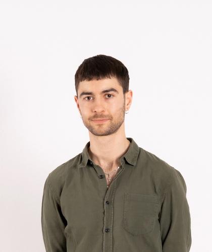 picture of keran with a slight smile and hands behind the back