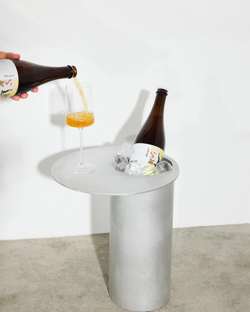 Photo of ENG 02 drink in glass next to bottle on stone background
