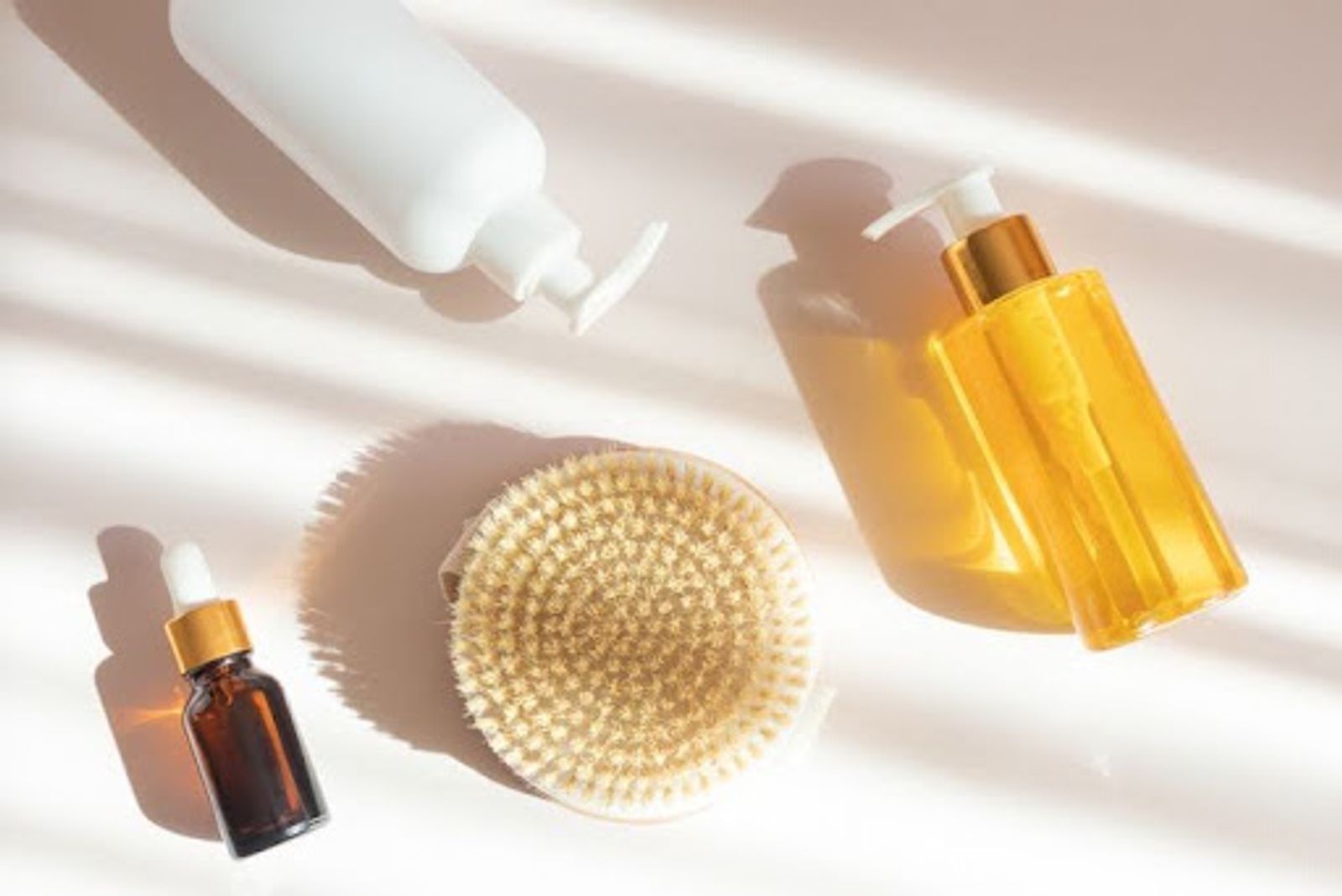 Image of 3 bottles against countertop with a dry brush in the center