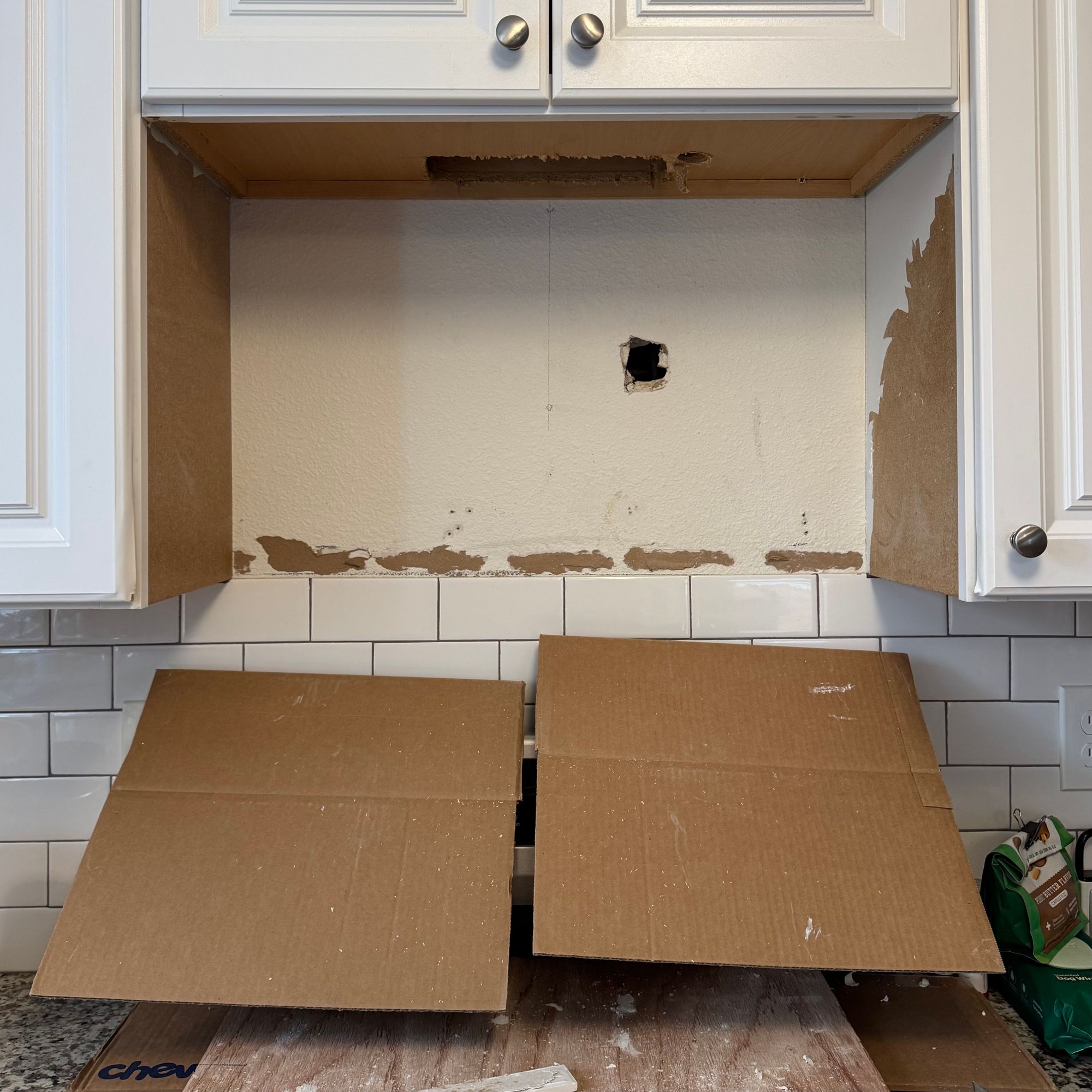 A hutch for an over-the-range microwave, under repair.