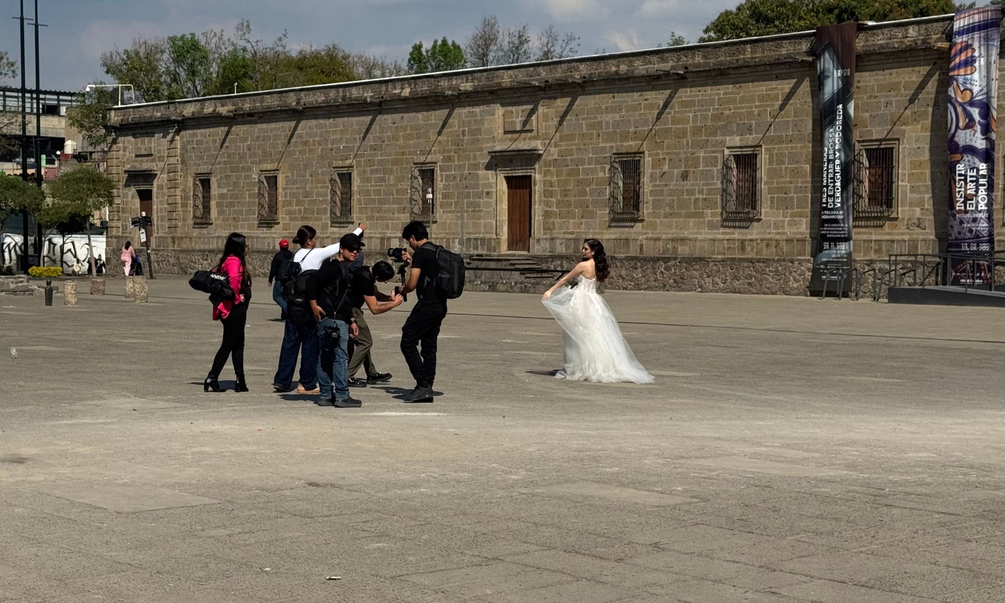 A young bride has her photo taken by a small crew of photographers
