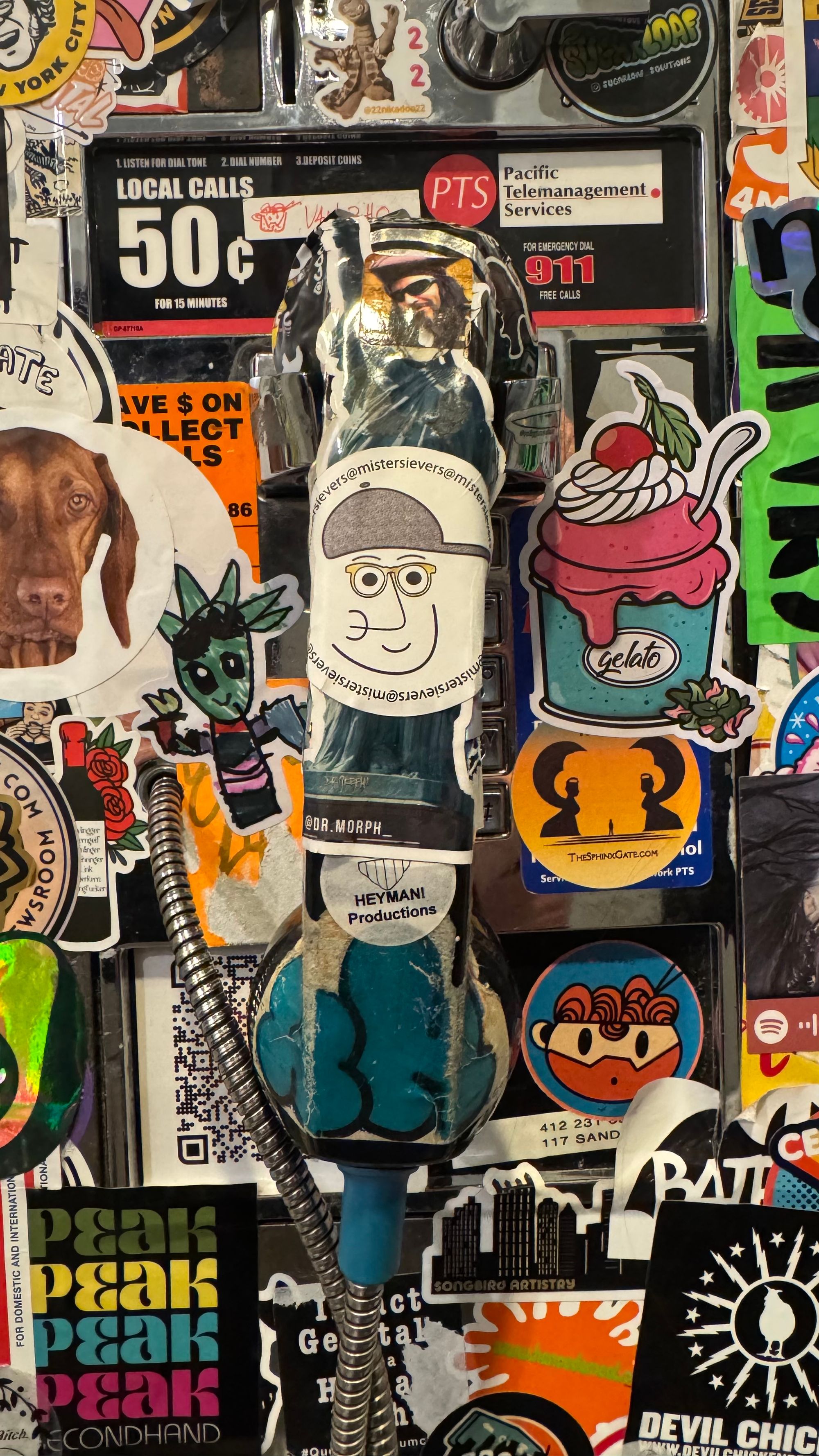 Sticker-encrusted pay phone on the bottom floor of the Warhol Museum