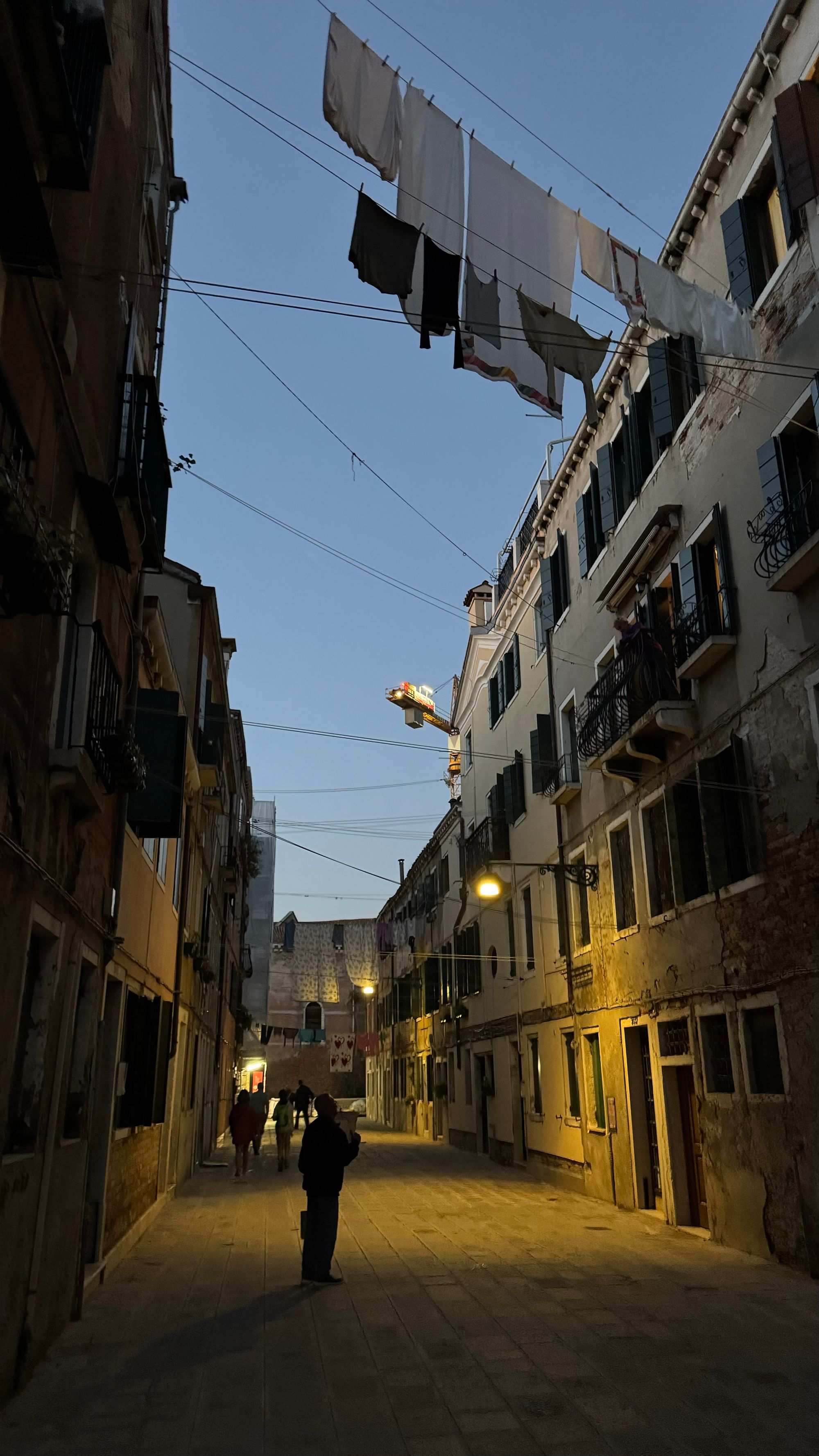 A quiet back street in Venice, with clotheslines overhead