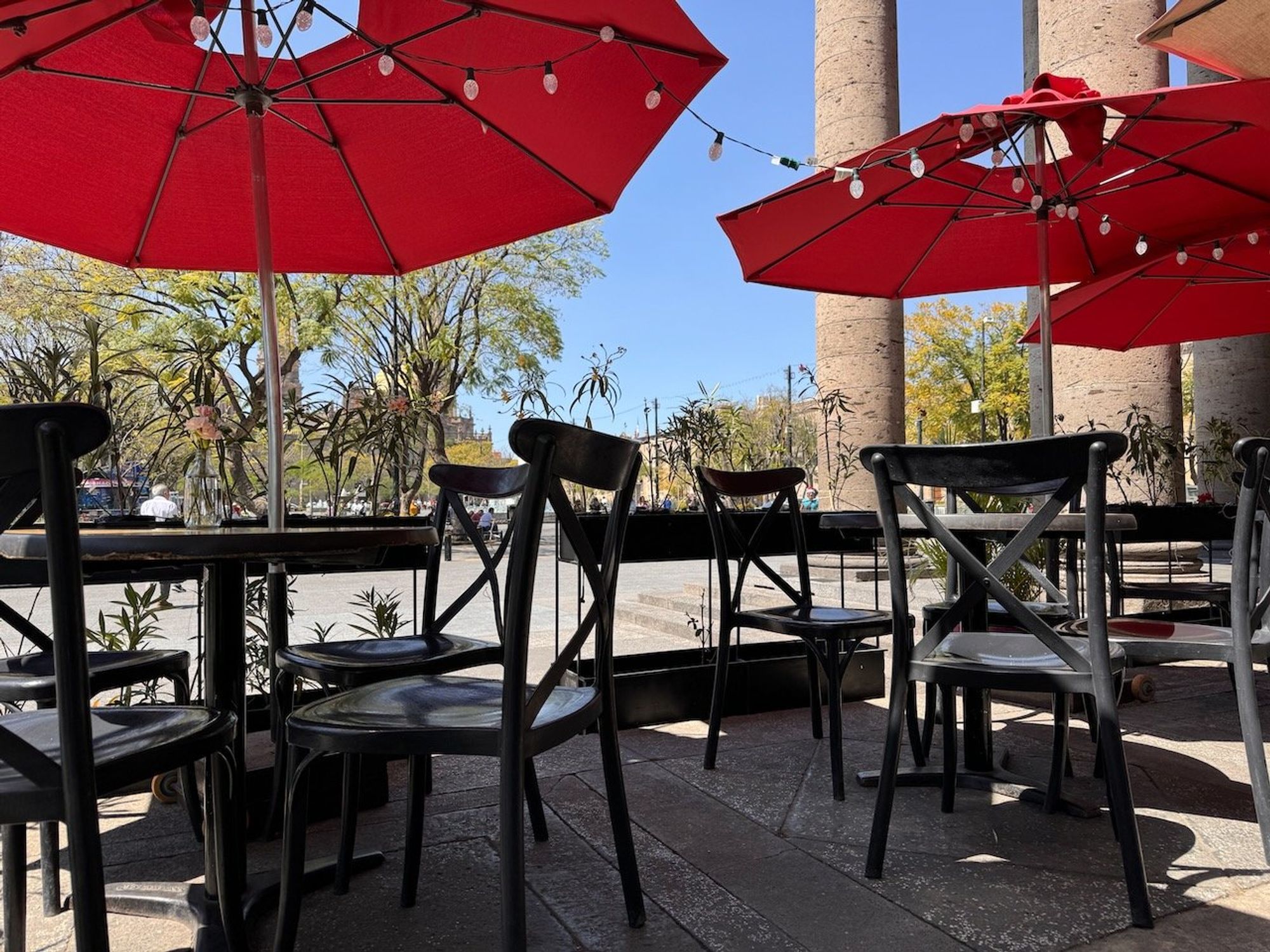 Red umbrellas over a café