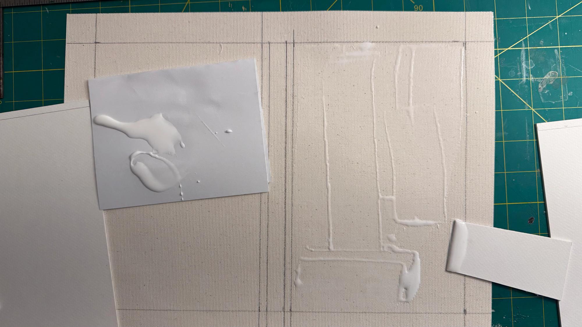 Gluing the illustration board to a sheet of canvas