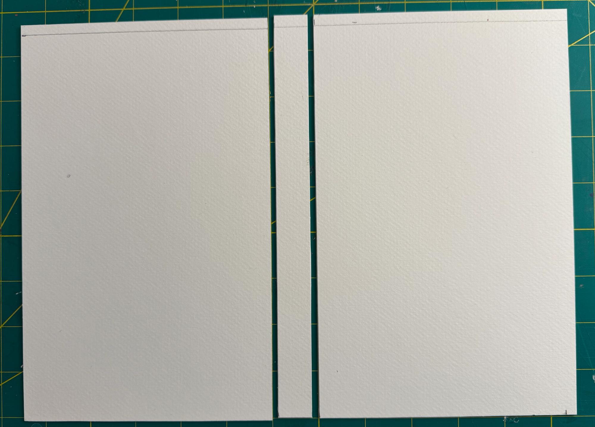 Illustration board cut to create book covers and a spine