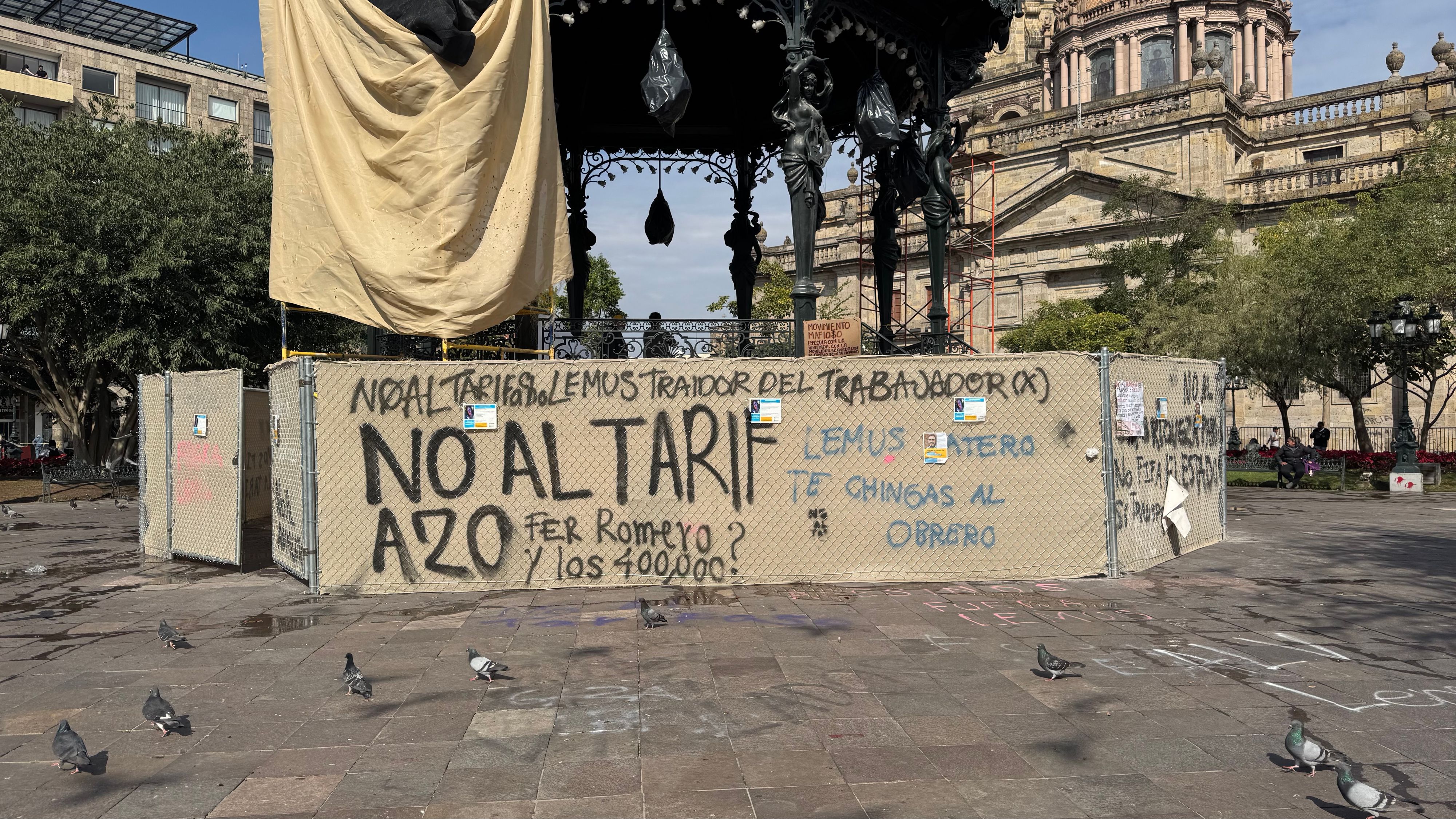 Anti-tariff graffiti spray painted on construction barriers