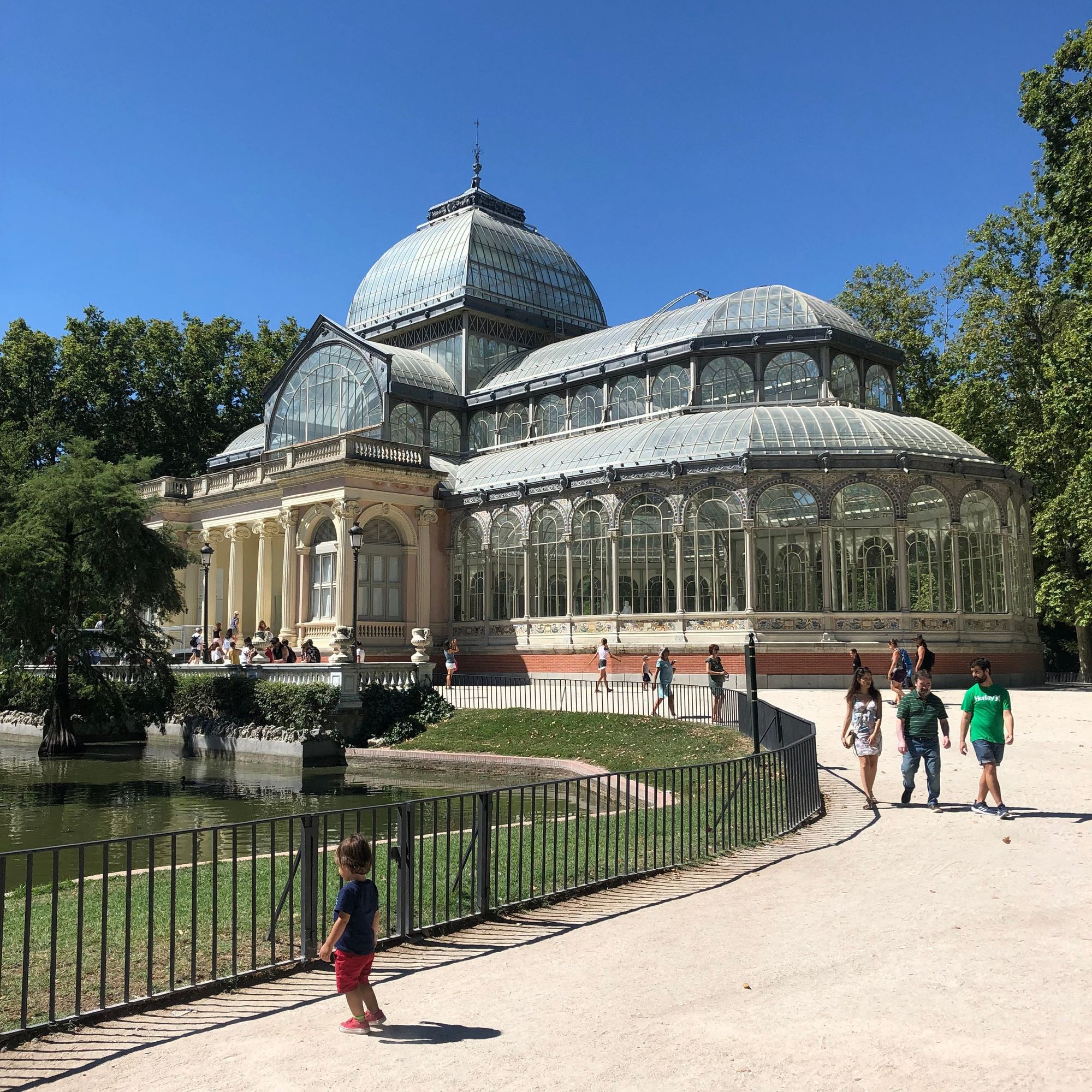 wrought iron and glass building in a park