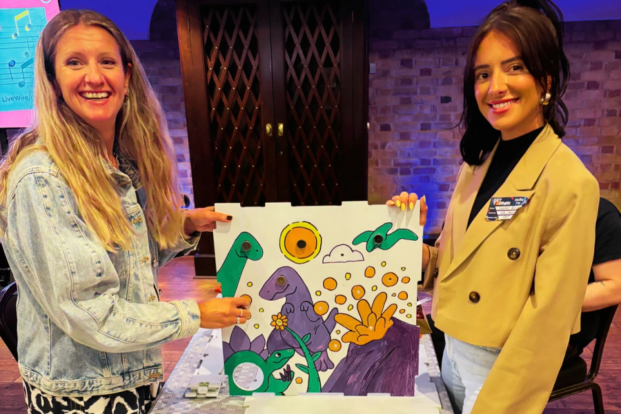 Two participants showing their LiveWire Adapted Musical Instrument design