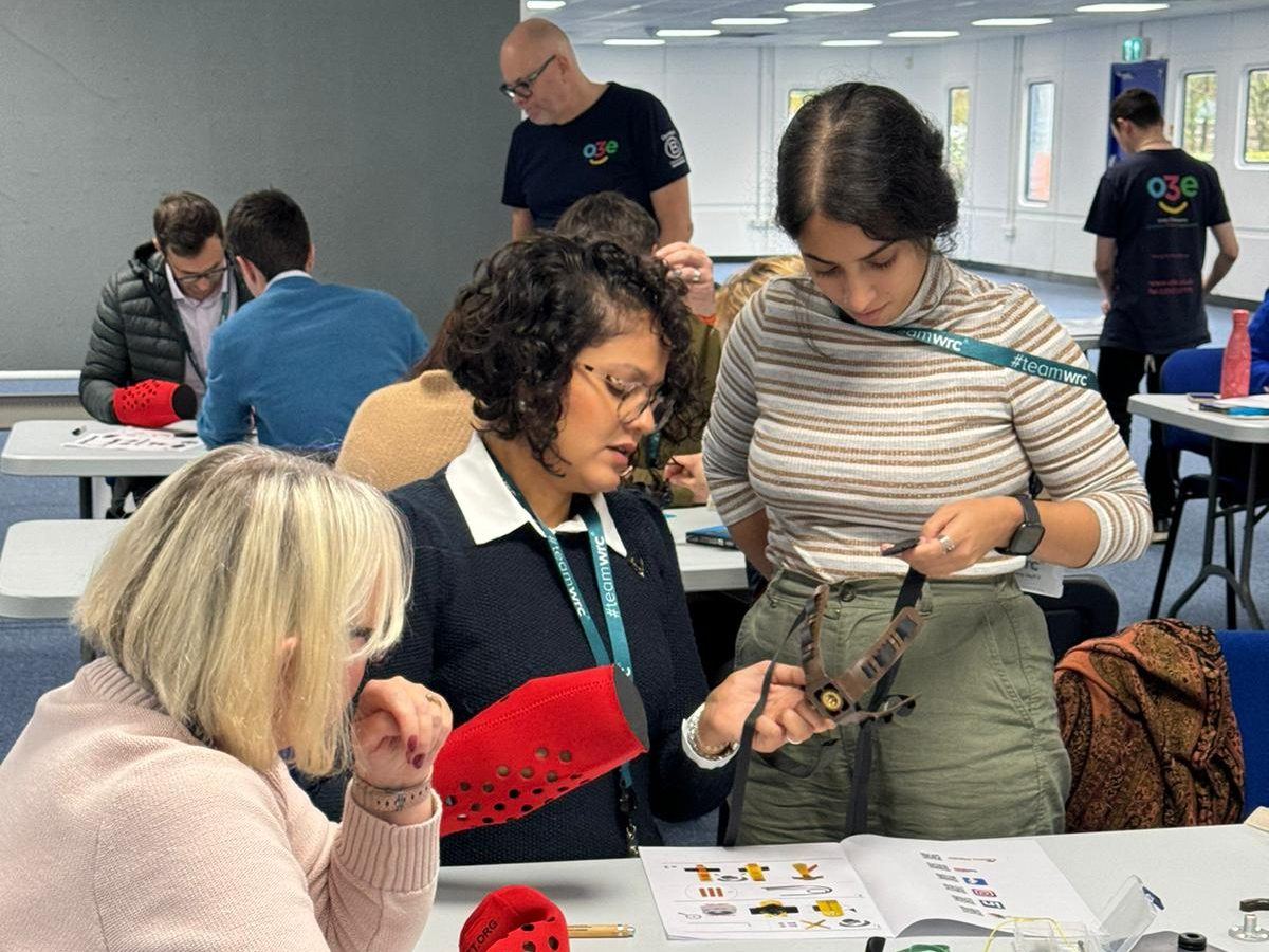 A team around a table assembling mechanical prosthetic hands