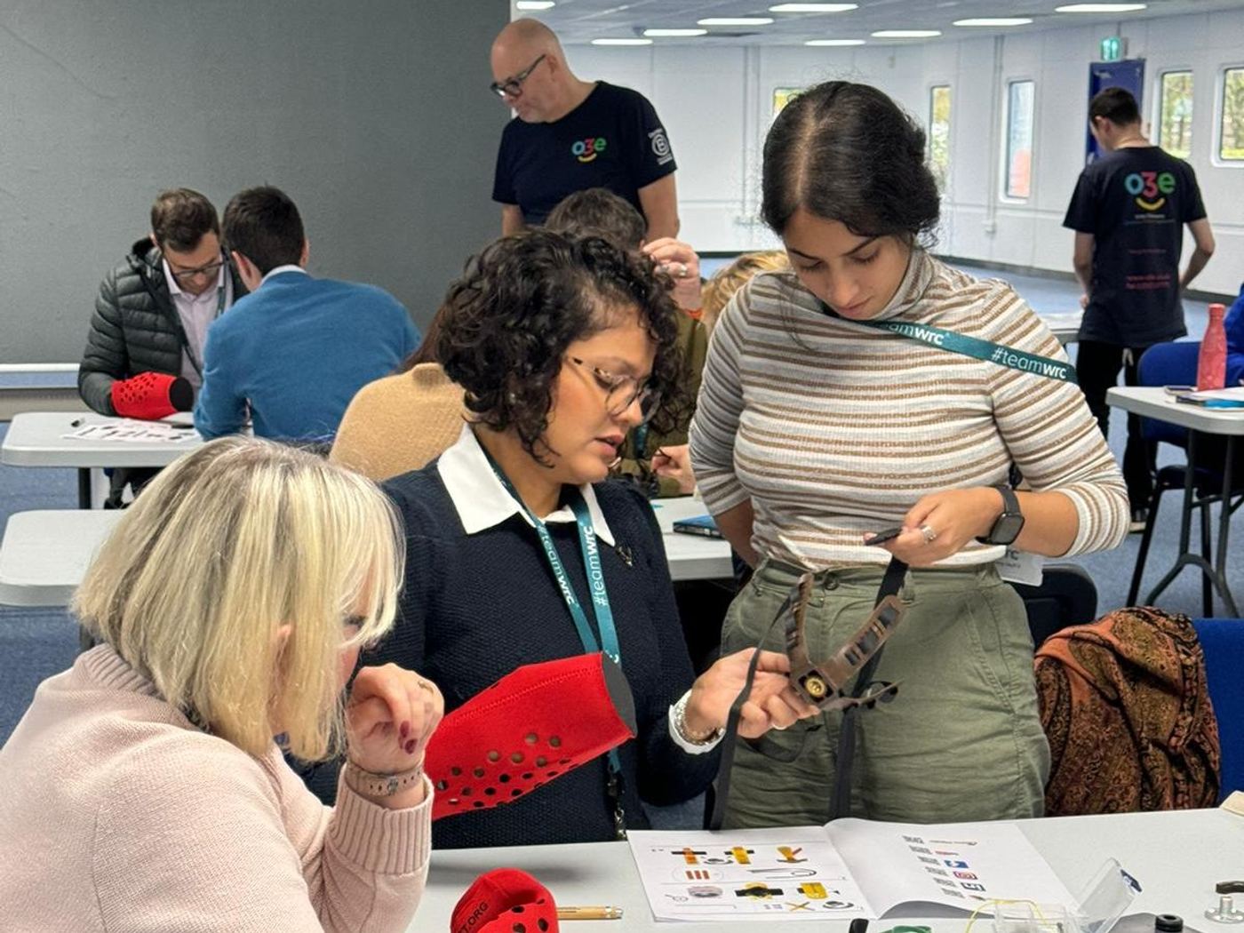 A team around a table assembling mechanical prosthetic hands