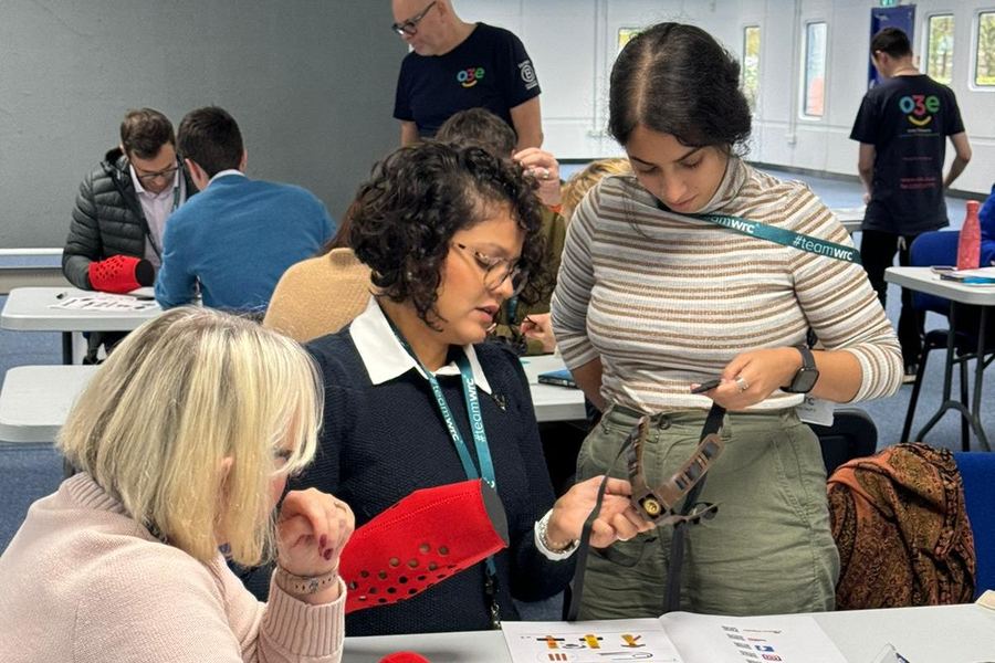 A team around a table assembling mechanical prosthetic hands