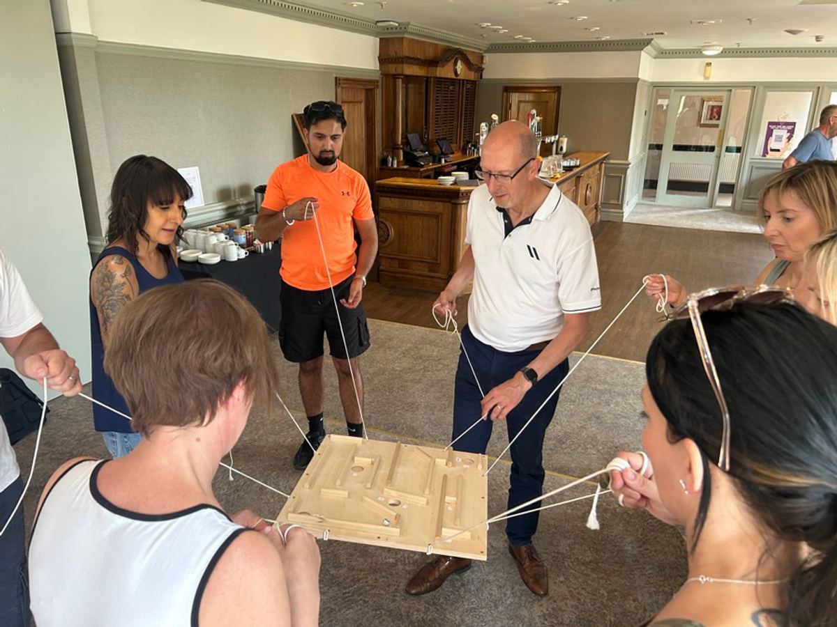 A team working out a build problem together around a table