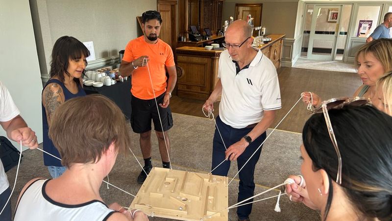 Charity team building in London: a team working through a build challenge together