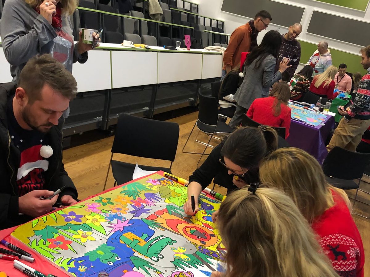 Charity team building in Scotland: a team decorating headboard panels for a child's bed