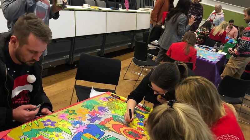 Charity team building in Scotland: a team decorating headboard panels for a child's bed