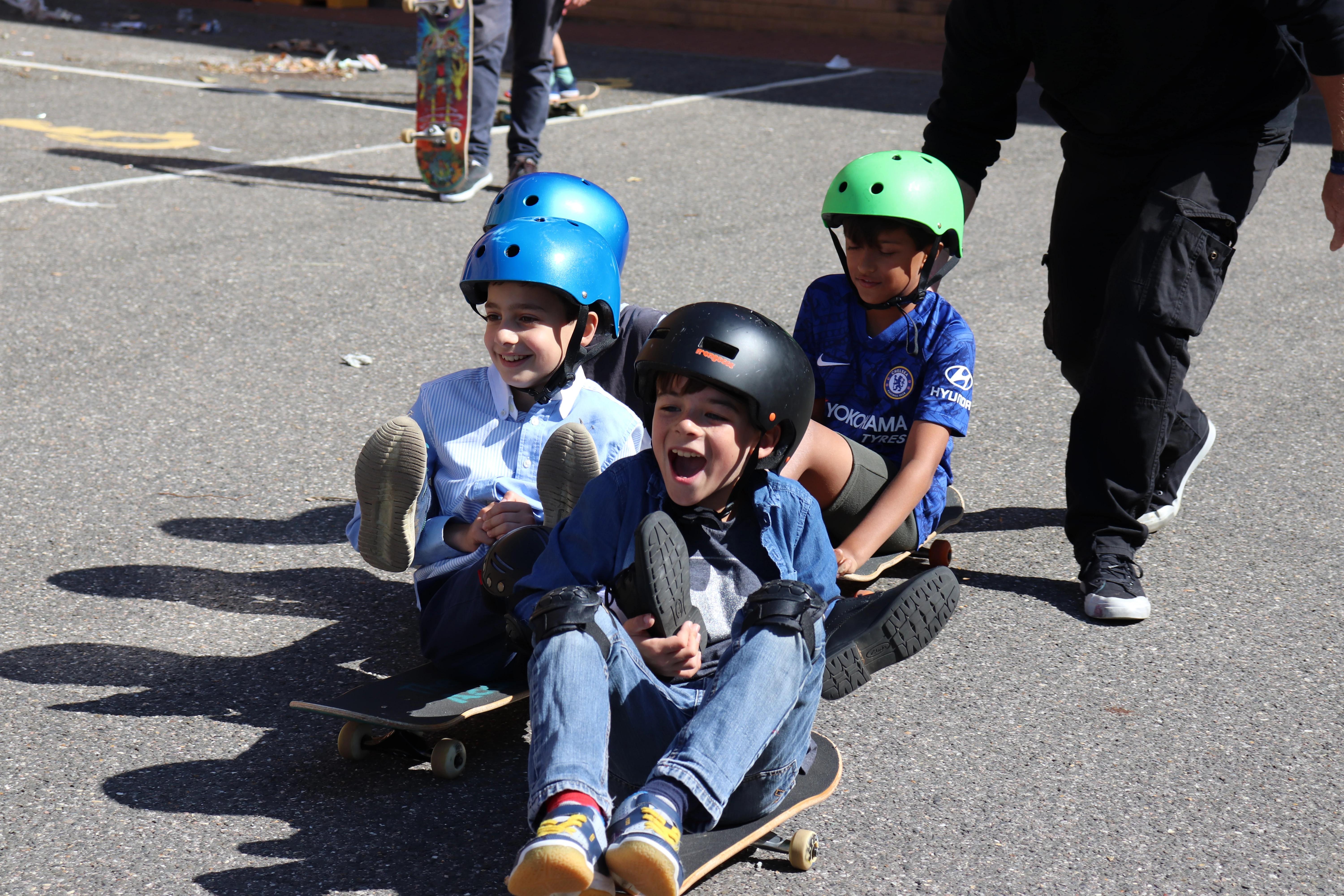 Children enjoying charity skateboard donation.