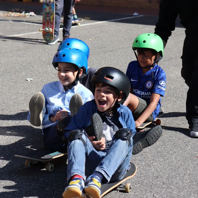 Children enjoying charity skateboard donation.