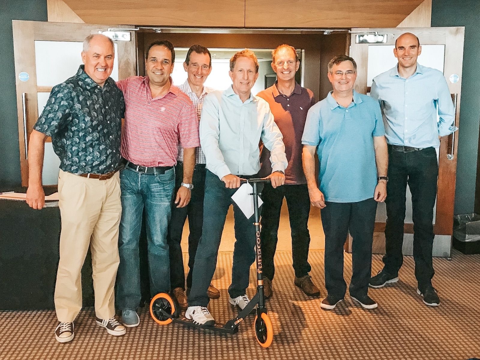 A team holding up the scooter they built for a children's charity