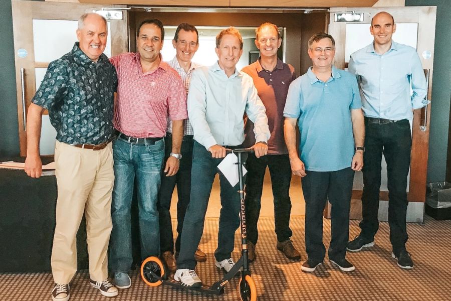 A team holding up the scooter they built for a children's charity