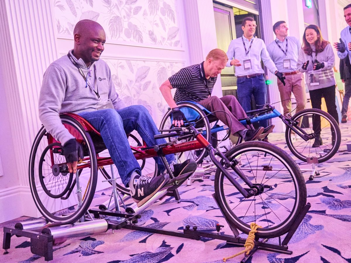 Two people competing in Racing Wheelchairs to win Ozone to help build a Sports Wheelchair
