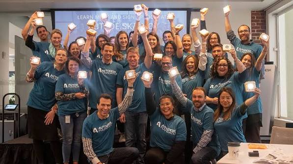 Team holding up their lit SolarBuddy