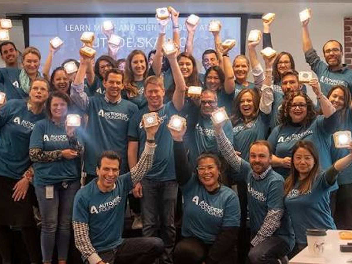 Team holding up their lit SolarBuddy