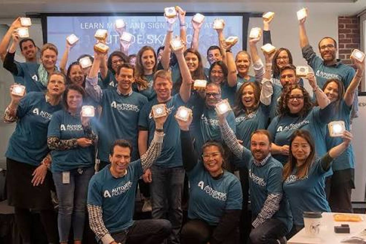 Team holding up their lit SolarBuddy