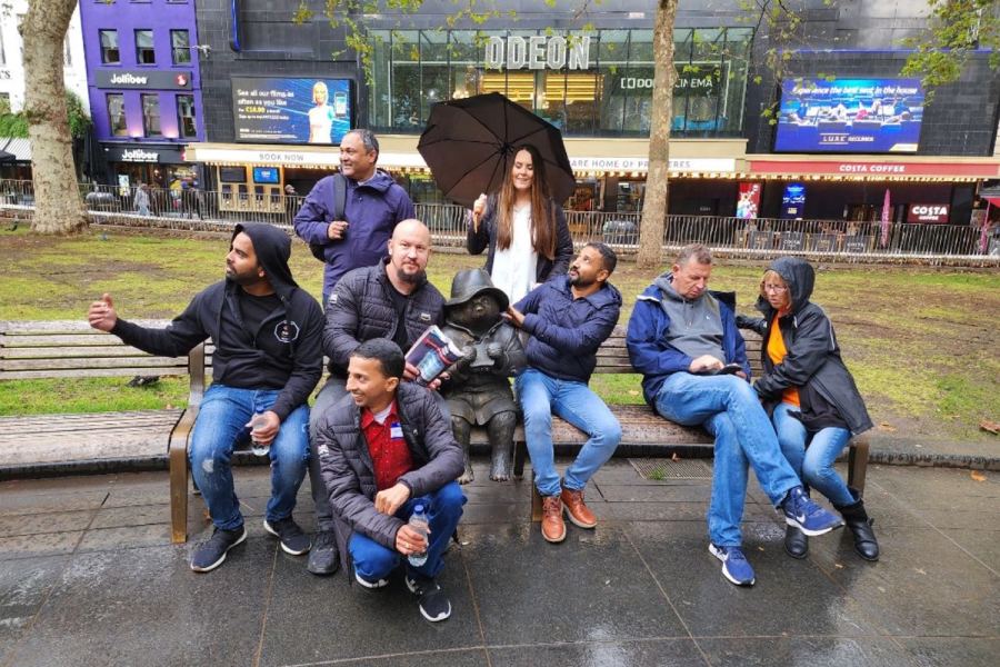 A Benevohunt team posing with the Paddington statue in Leicester Square