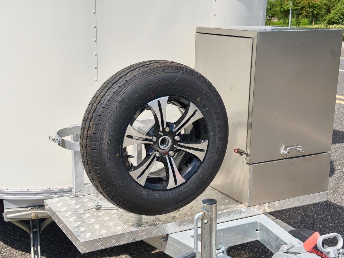 Spare tire and heavy duty generator box mounted on a Chris Machinery food trailer hitch