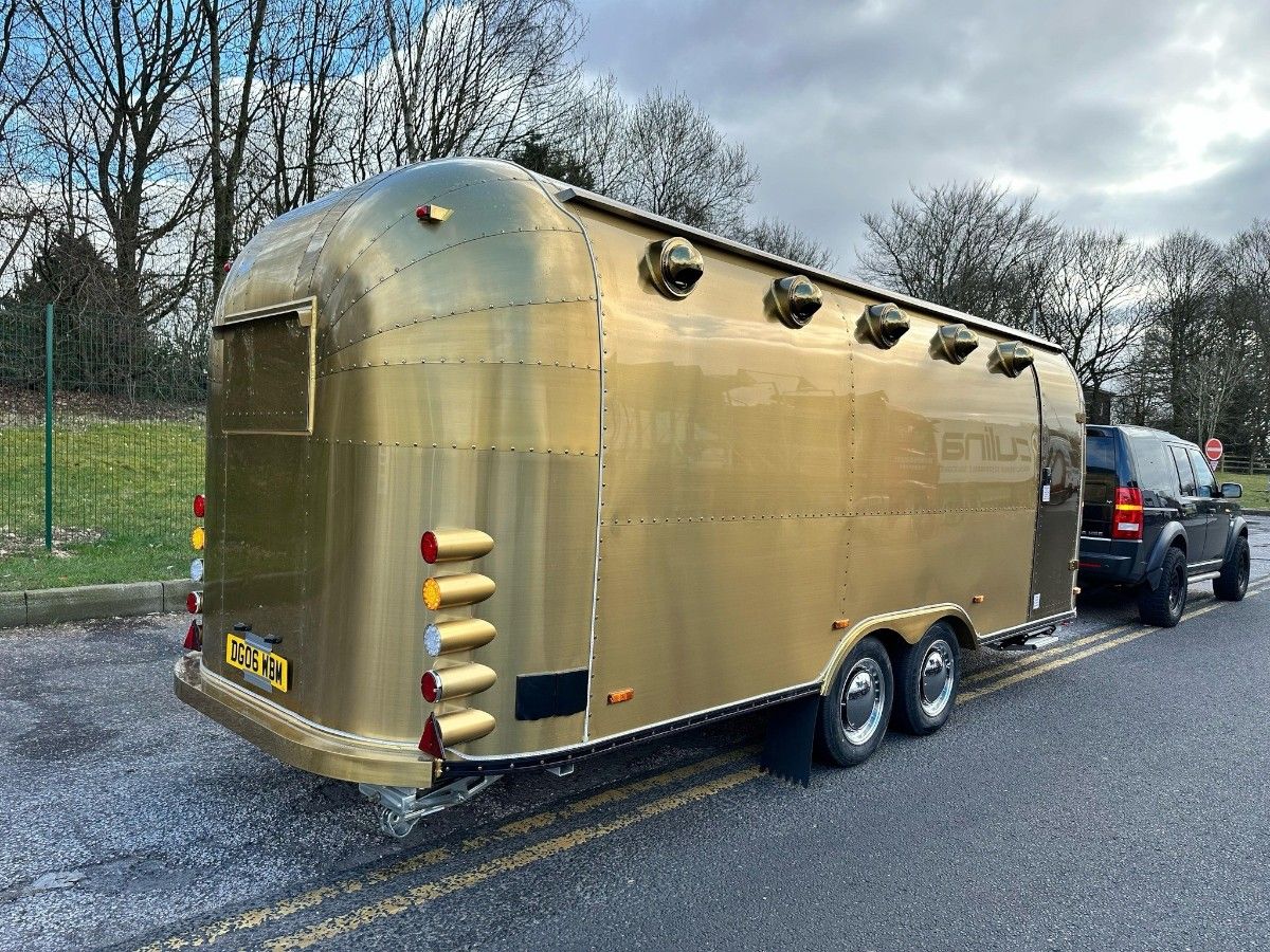 Luxury gold finished Chris Machinery Airstream food truck parked in customer lot