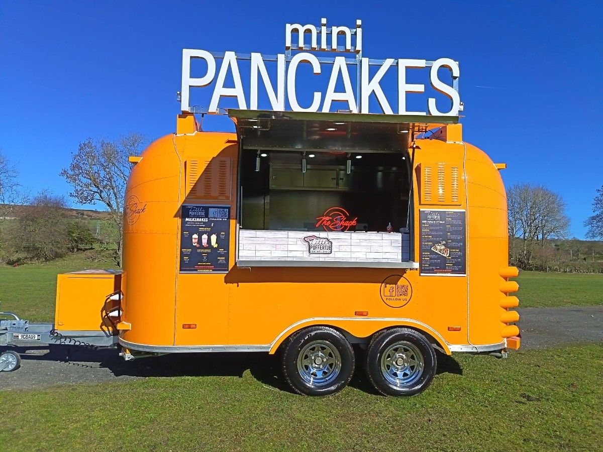 Bright yellow mini pancakes food trailer customized and manufactured by Chris Machinery
