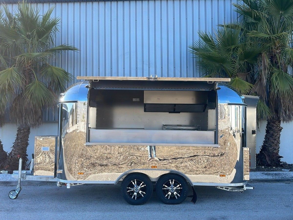 Chris Machinery stainless steel Airstream food trailer operating at palm tree resort