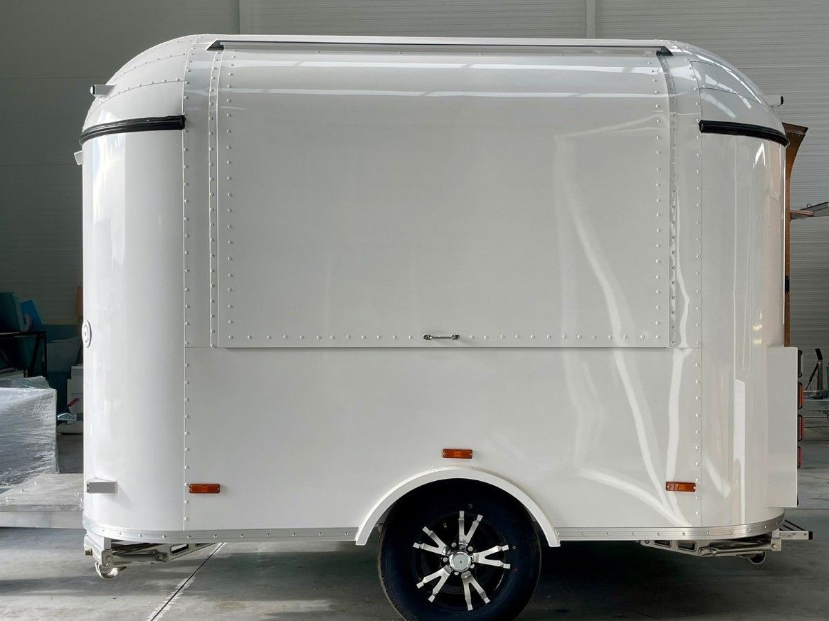 Pure white Chris Machinery mobile concession trailer parked outdoors ready for delivery