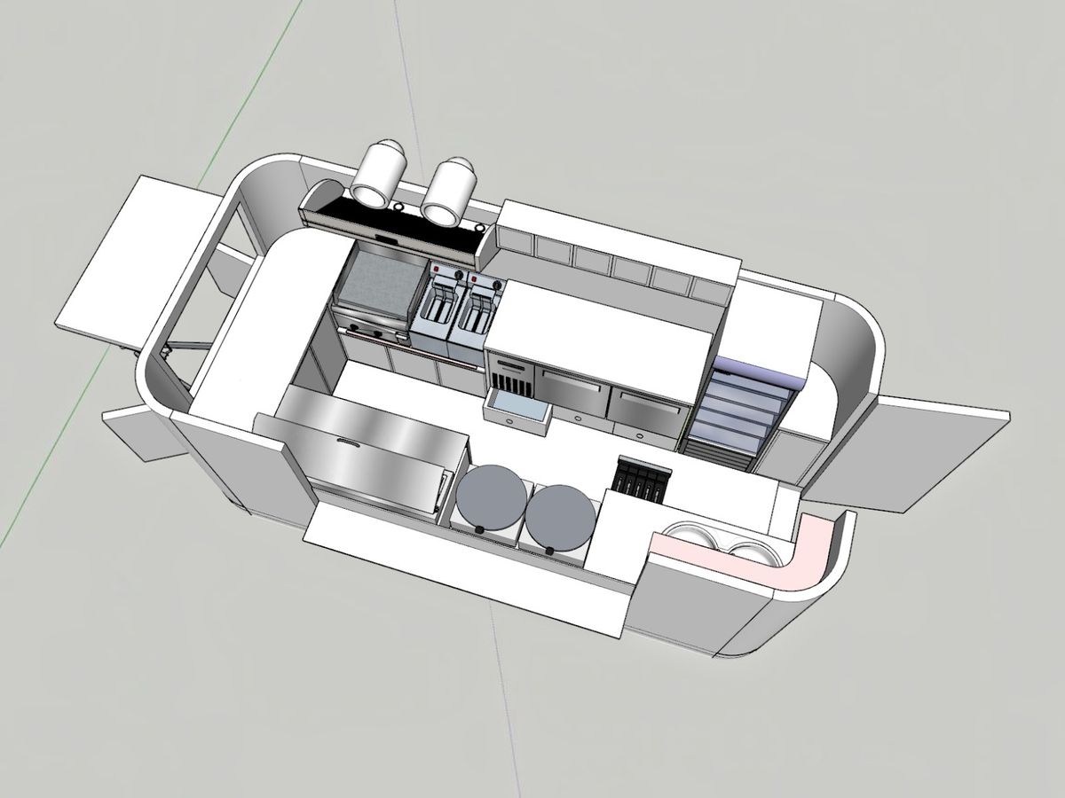 Chris Machinery engineers reviewing custom food trailer drawings and new layout designs