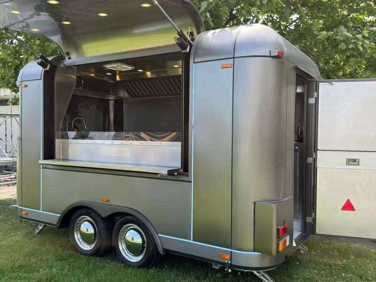 Chris Machinery silver Airstream food truck parked outside customer commercial site