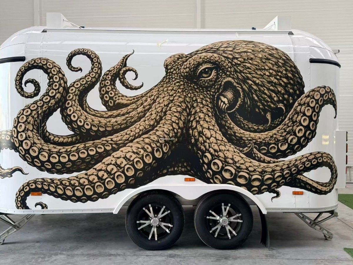 Chris Machinery custom white food trailer with distinctive octopus artwork graphic wrap