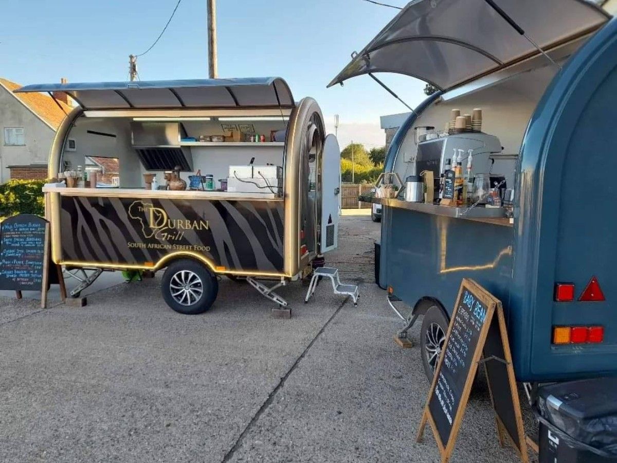 Chris Machinery custom black and blue food trailers operating at customer street market