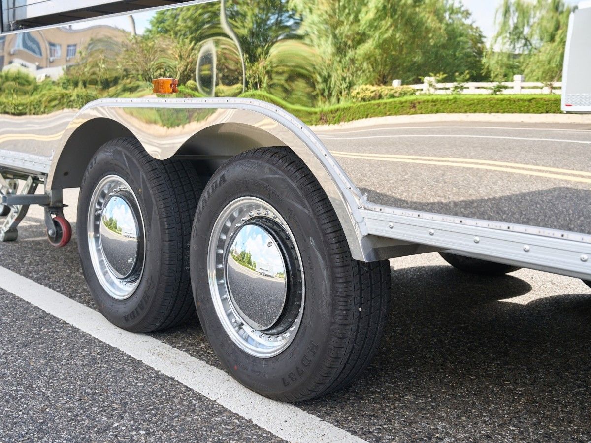 Heavy duty dual axle suspension with chrome mudguards on a Chris Machinery trailer chassis