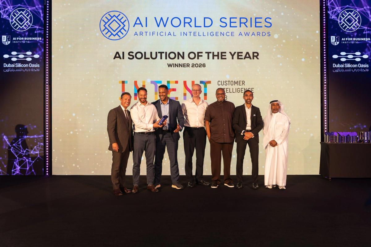 The Intent HQ team on stage at the AI World Series Awards in Dubai, holding the trophy beneath a screen that reads AI Solution of the Year, Winner 2026.