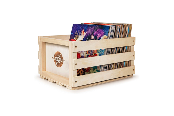 A beautifully crafted, rustic wooden vinyl record storage crate filled with classic record albums, styled next to a mid-century modern record player.