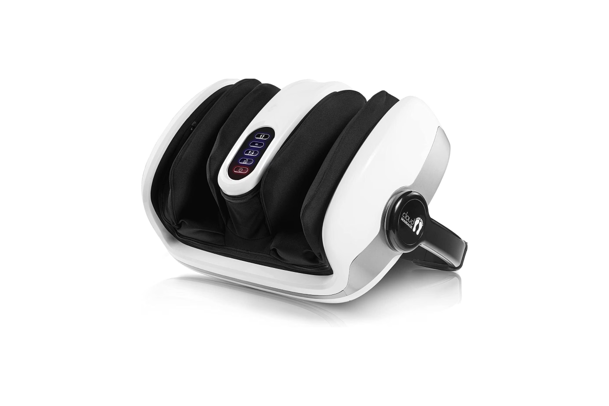 A sleek, modern electric Shiatsu foot massager with glowing heated nodes sitting on a living room rug.