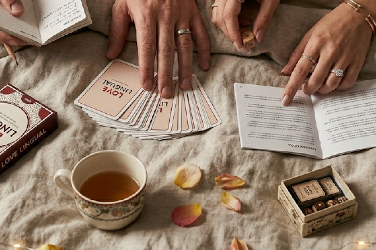 A colorful modern strategy card game set up on a bed with tea nearby for a date night.