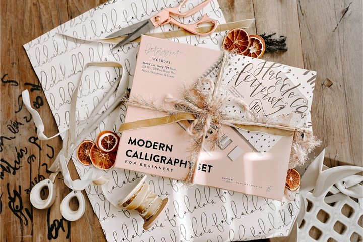 A calligraphy set beautifully laid out among gift wraps.