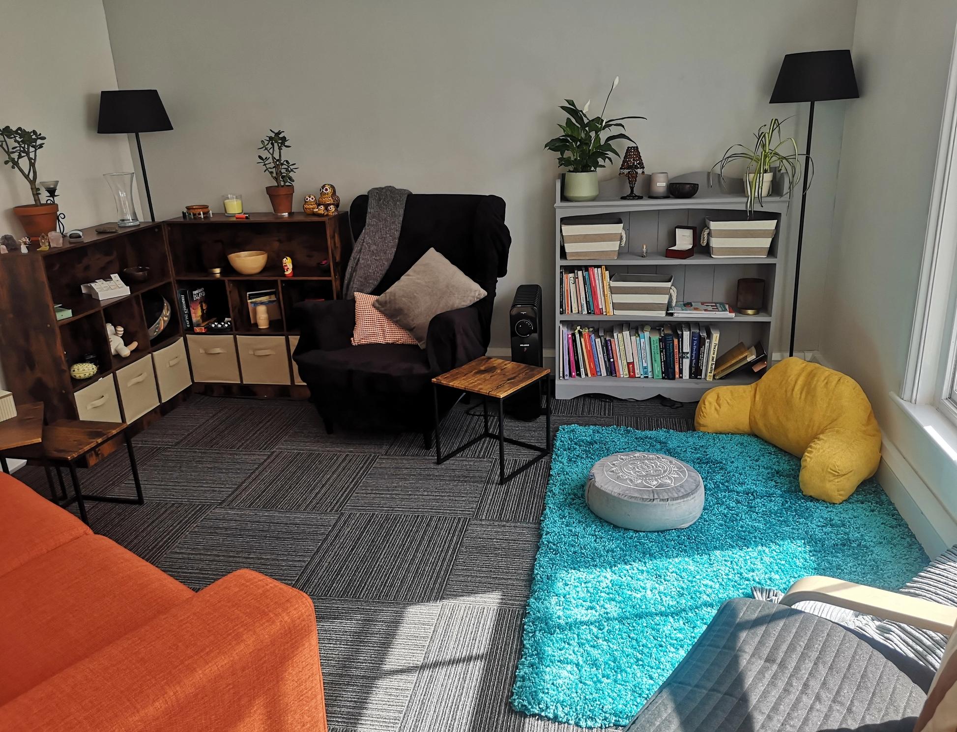 A room with armchairs and cushions in bright daylight