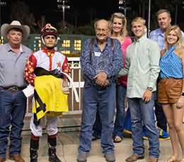 Owner Bill Price holding the Golden State Derby trophy while joined by his family, Monty Arrossa and Armando Cervantes.