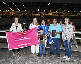 The winning connections of Karma Cha Ching accept the Sam Houston Oaks stakes trophy at Sam Houston Race Park.