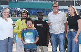 The winning connections of Fl Rizzo accept the Walter Merrick Stakes trophy at Fair Meadows.