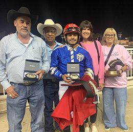 The winning connections of Invasive accept the Adequan California Derby Challenge trophy at Los Alamitos on Sunday.